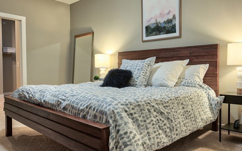 bedroom with large windows and nightstand