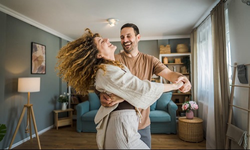 a couple dancing in their living room